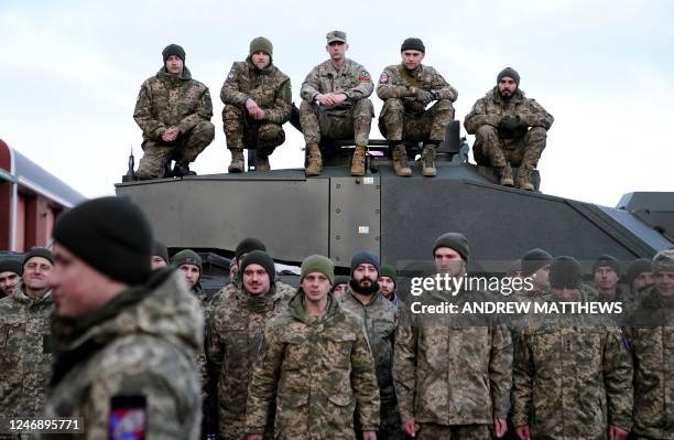 Soldiers gather as Ukraine's President Volodymyr Zelensky and Britain's Prime Minister Rishi Sunak meet Ukrainian troops being trained to command...