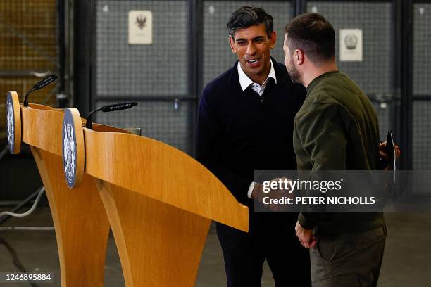 Ukraine's President Volodymyr Zelensky and Britain's Prime Minister Rishi Sunak shake hands at the end of their joint press conference at a military...