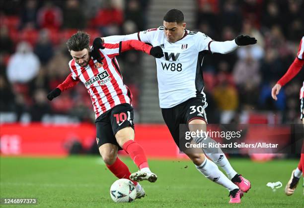 Patrick Roberts of Sunderland and Carlos Vinicius of Fulham challenge during the FA Cup Fourth Round replay match between Sunderland FC and Fulham FC...