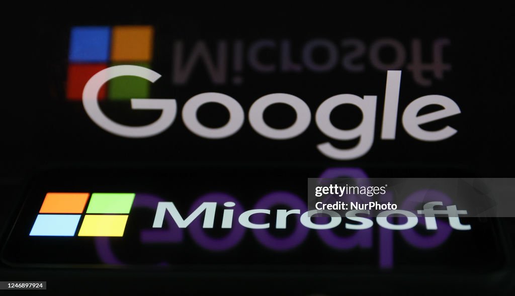 Google logo displayed on a laptop screen and Microsoft logo displayed ...