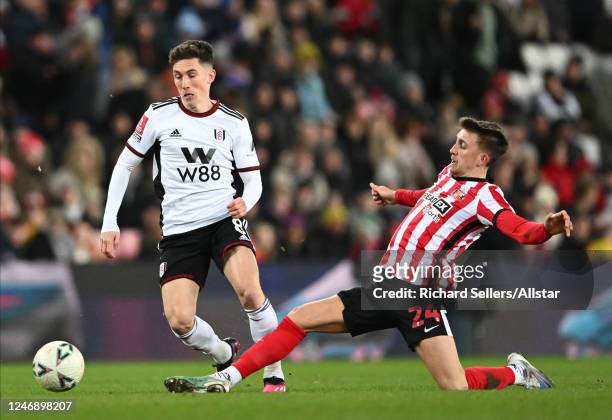 Harry Wilson of Fulham and Dan Neil of Sunderland challenge during the FA Cup Fourth Round replay match between Sunderland FC and Fulham FC at...