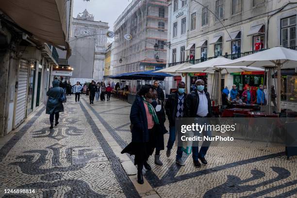 People using protective mask are seen walking along one of the streets in the Baixa district. Lisbon, January 23, 2023. In Portugal, the...