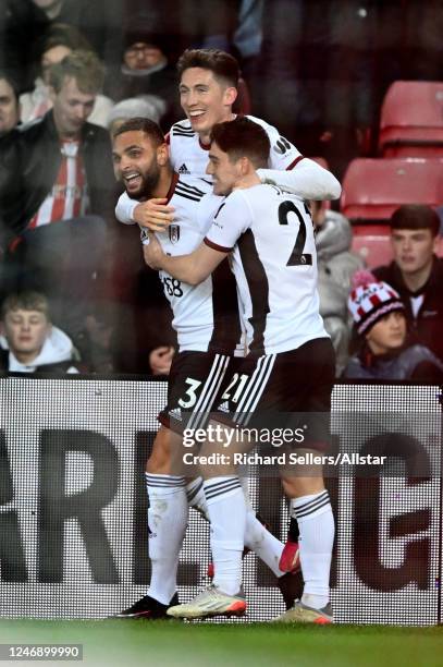 Layvin Kurzawa of Fulham celebrates with team-mates Harry Wilson and Daniel James after scoring their team's 3rd goal during the FA Cup Fourth Round...