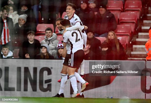 Layvin Kurzawa of Fulham celebrates with team-mates Harry Wilson and Daniel James after scoring their team's 3rd goal during the FA Cup Fourth Round...