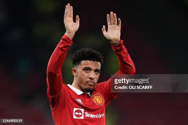 Manchester United's English striker Jadon Sancho waves at the end of the the English Premier League football match between Manchester United and...