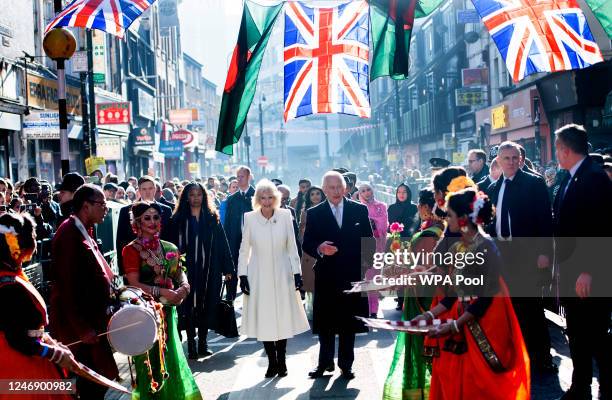 King Charles III and Camilla, Queen Consort meet members of the public during a visit to the Bangladeshi community of Brick Lane on February 8, 2023...