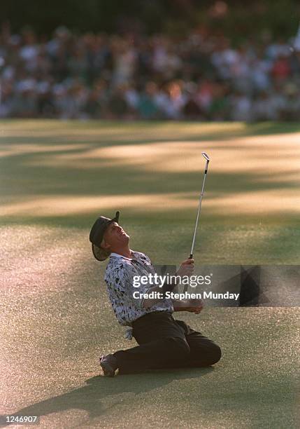 Greg Norman of Australia collapses on the ground after narrowly missing his chip shot on the 15th green during the final tound of the 1996 US Masters...