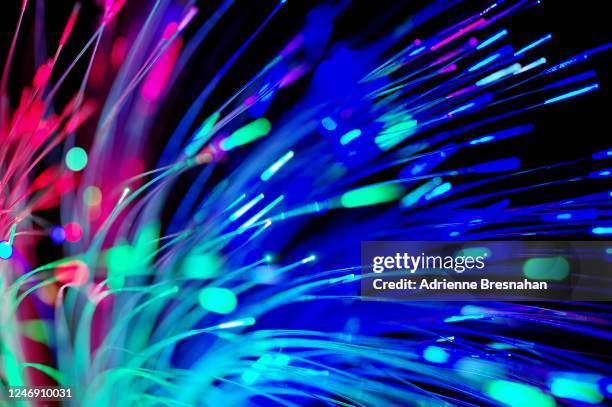 fiber optics against black background - spark imagination stock pictures, royalty-free photos & images