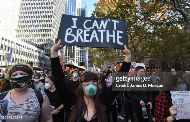 Female protester holds a sign declaring "I can't breathe" in solidarity with "Black Lives Matter" on June 06, 2020 in Sydney, Australia. The event...