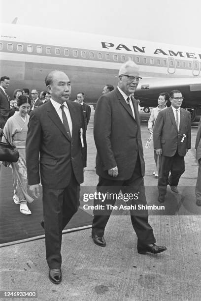 Chief Justice Earl Warren and his wife Nina are welcomed by Japanese Chief Justice Kisaburo Yokota on arrival at Haneda Airport on September 2, 1967...