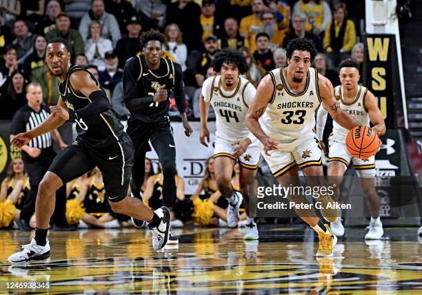 James Rojas of the Wichita State Shockers drives the ball up court against C.J. Kelly of the UCF Knights during a game in the first half at Charles...