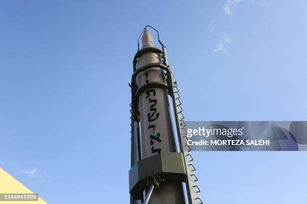 An Iranian long-range Ghadr missile displaying "Down with Israel" in Hebrew is pictured at a defence exhibition in city of Isfahan, central Iran, on...