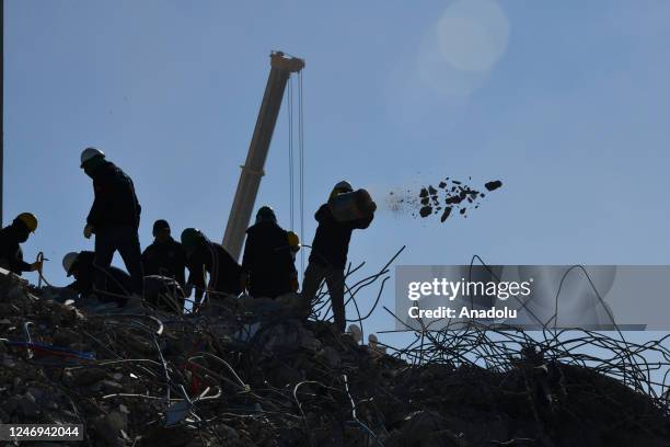 Search and rescue crew member empties rubbles from a bucket as works continue at collapsed Ayse Polat Residential Site in Sehitkamil district after...