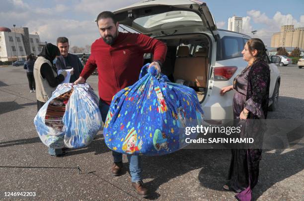 Iraqi volunteers collect donated blankets in Arbil, the capital of Iraq's northern autonomous Kurdish region, on February 9 to be sent to Turkey and...