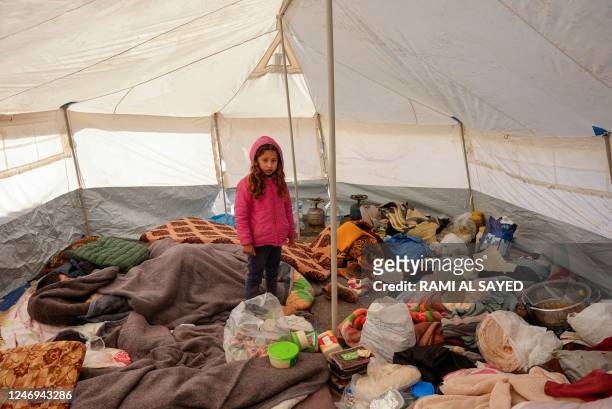 Syrian girl is pictured in a tent at a makeshift shelter for people who were left homeless, near the rebel-held town of Jindayris on February 9 two...