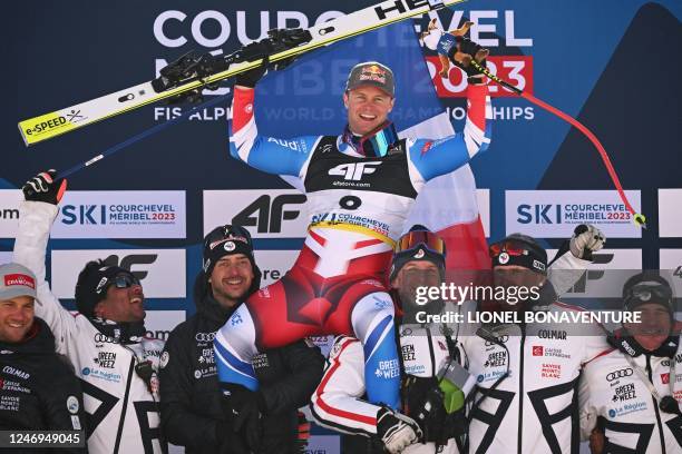 Third placed France's Alexis Pinturault celebrates with teammates on the podium after the Men's Super-G event of the FIS Alpine Ski World...