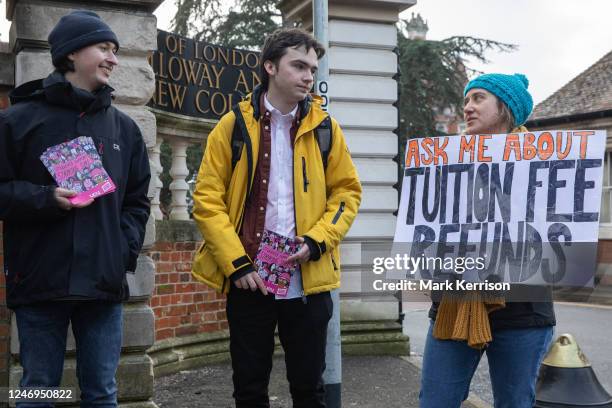 University staff from the University and College Union and supporters stand holding signs and leaflets at an official picket outside Royal Holloway...
