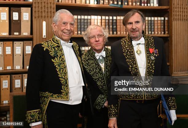 Peruvian writer and Nobel literature prize winner Mario Vargas Llosa poses for a photograph with writer and historian Pascal Ory and French writer...