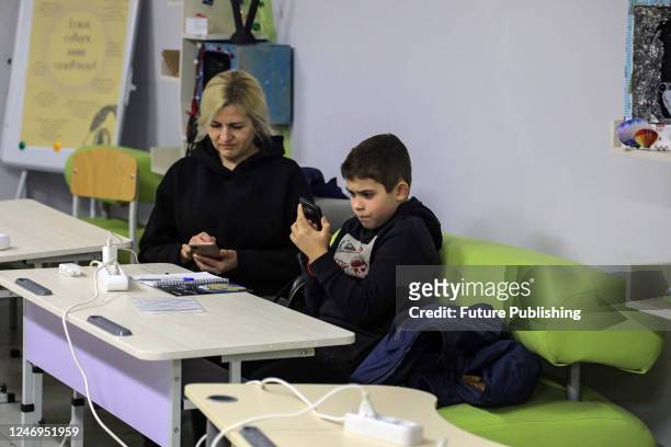 Woman and a boy charge their phones and access the Internet in a Point of Invincibility in Odesa, southern Ukraine. Odesa and the region experience a...