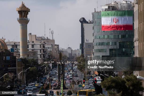 Giant Iran flag is hanged from a state building in downtown Tehran on the eve of the Islamic Revolution victory anniversary, February 8, 2023. The...