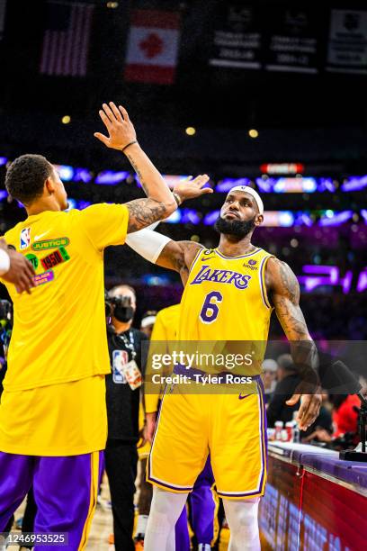 LeBron James and Juan Toscano-Anderson of the Los Angeles Lakers high five before the game against the Oklahoma City Thunder on February 7, 2023 at...