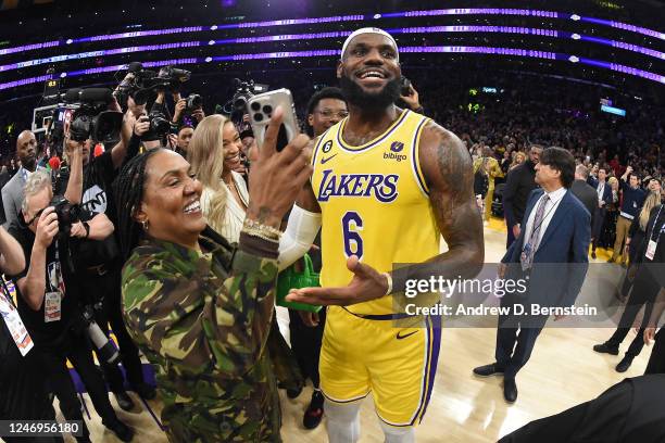 Gloria James and LeBron James of the Los Angeles Lakers celebrate on court after the becomes the NBA All Time Leading Scorer during the game against...