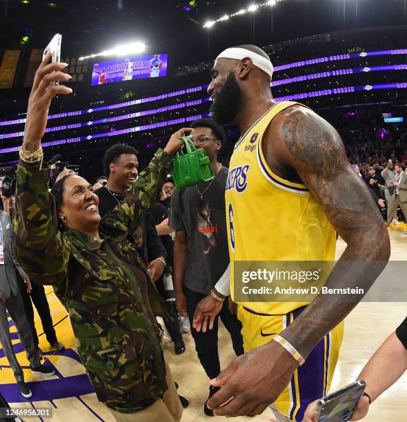 Gloria James and LeBron James of the Los Angeles Lakers celebrate on court after the becomes the NBA All Time Leading Scorer during the game against...