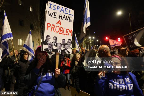 Israeli protesters attend a rally against Prime Minister Benjamin Netanyahu's new hard-right government near the Israeli prime minister's residence...