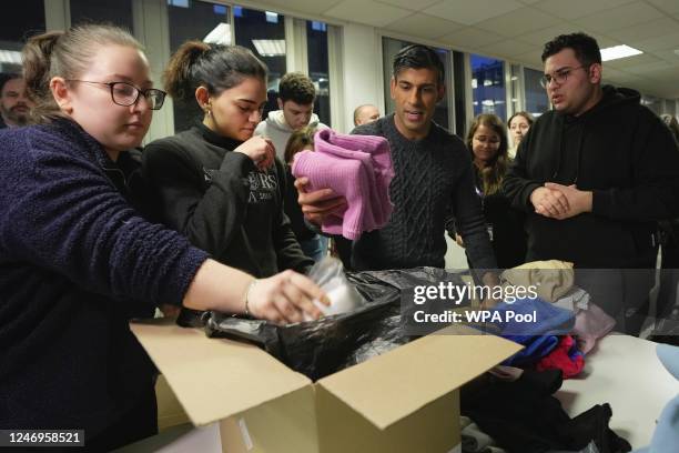 British Prime Minister Rishi Sunak helps to pack the supplies at a donation centre that is supporting the Turkey earthquake appeal on February 9,...