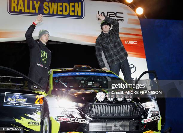 Oliver Solberg of Sweden and his co-driver Elliott Edmondson of Great Britain stand by their Skoda Fabia RS during the 1st stage of the Rally Sweden,...