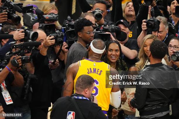 Los Angeles Lakers LeBron James celebrates with his mother Gloria James, wife Savannah James and sons Bryce Maximus and Bronny James after breaking...
