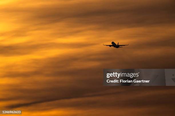 Plane is pictured in front of the dusk near the BER airport on February 09, 2023 in Berlin, Germany.