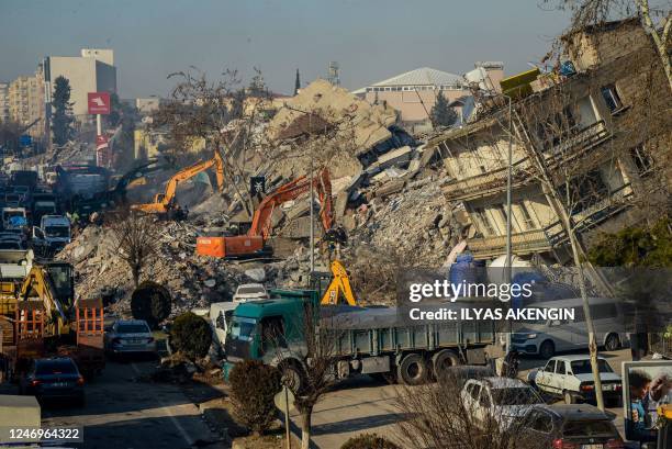 Bulldozers work among the rubble of collapsed buildings in Adiyaman, Turkey on February 9 three days after a 7,8-magnitude earthquake struck...