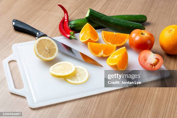 fruits and vegetables on a white chopping board - cutting board stock pictures, royalty-free photos & images