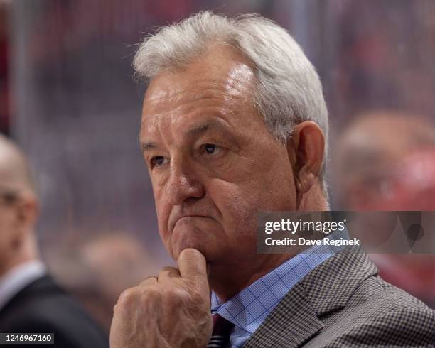 Head coach Darryl Sutter of the Calgary Flames watches the action from the bench against the Detroit Red Wings during the first period of an NHL game...