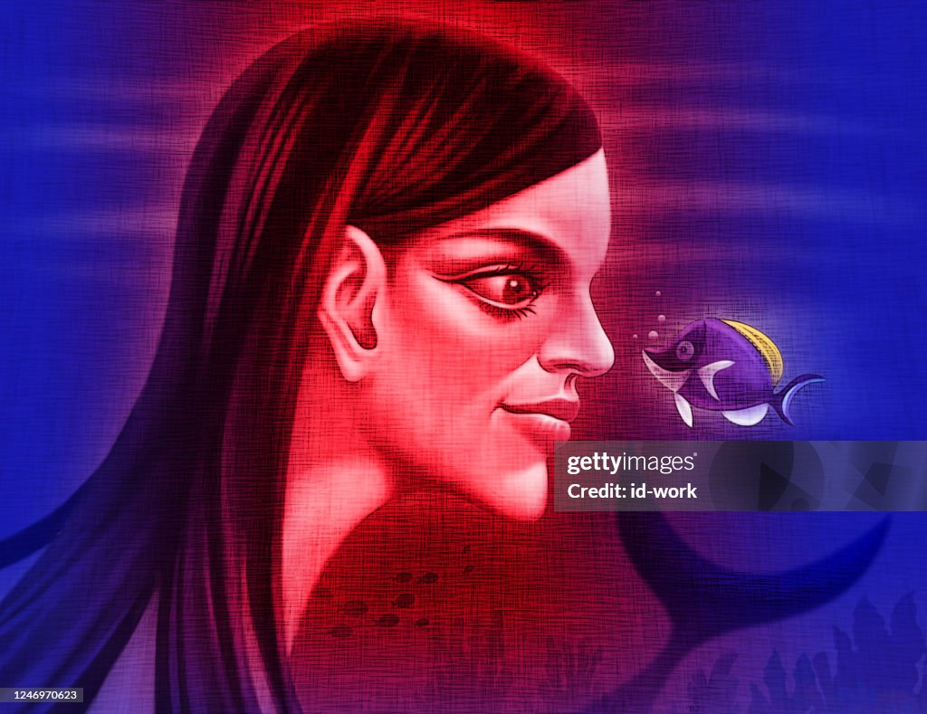 Mermaid looking at blue surgeon fish