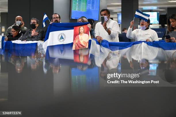 People gather at Dulles International Airport to welcome back political prisoners being released from Nicaragua on Thursday February 09, 2023 in...