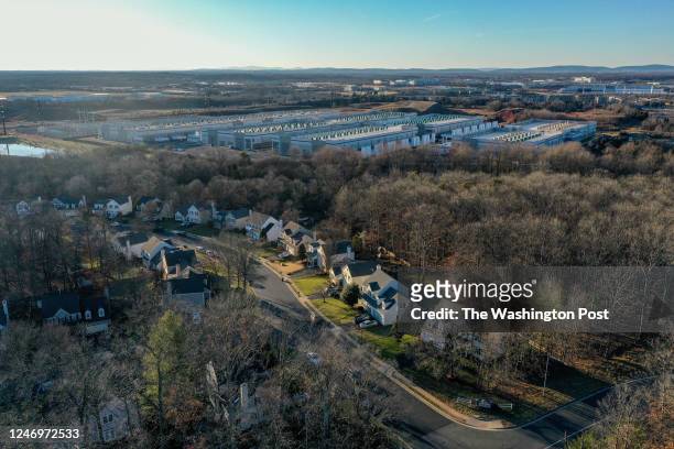 Amazon Web Services data centers, top center, have been built next to the Great Oak neighborhood, January 24 in Manassas, VA. As the data center...