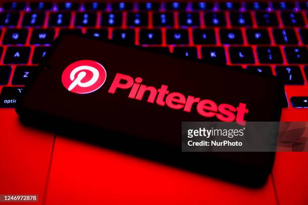 Pinterest logo is displayed on a mobile phone screen for illustration photo. Krakow, Poland on February 9, 2023.