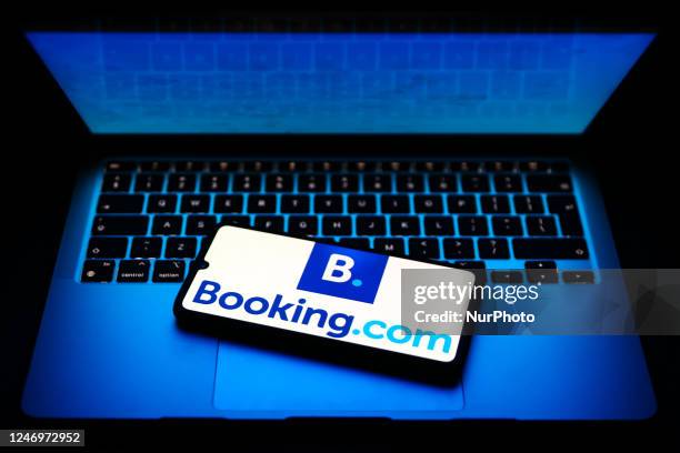 Booking.com name is displayed on a mobile phone screen for illustration photo. Krakow, Poland on February 9, 2023.