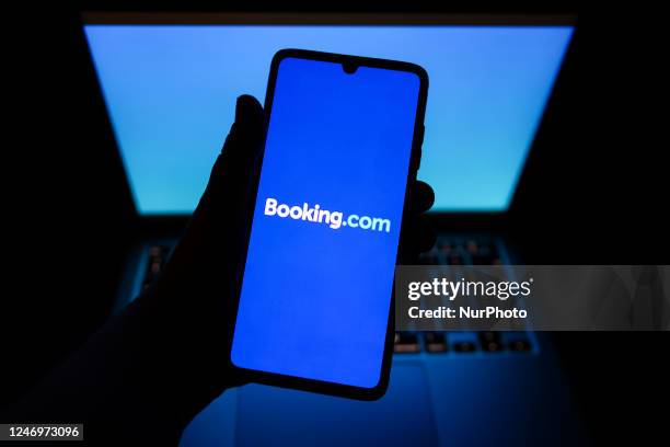 Booking.com name is displayed on a mobile phone screen for illustration photo. Krakow, Poland on February 9, 2023.