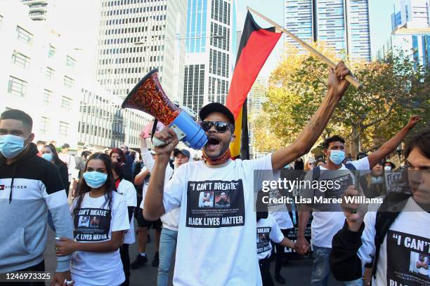 Protesters chant and hold placards at Town Hall during a 'Black Lives Matter' protest march June 06, 2020 in Sydney, Australia. Events across...