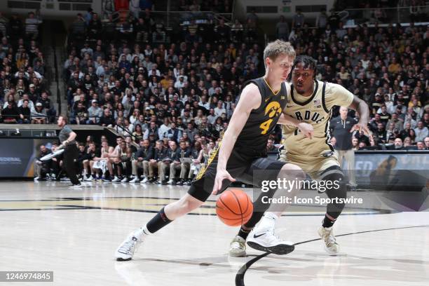 Iowa Hawkeyes guard Josh Dix drives to the basket against Purdue Boilermakers guard David Jenkins Jr. On February 9 at Mackey Arena in West...