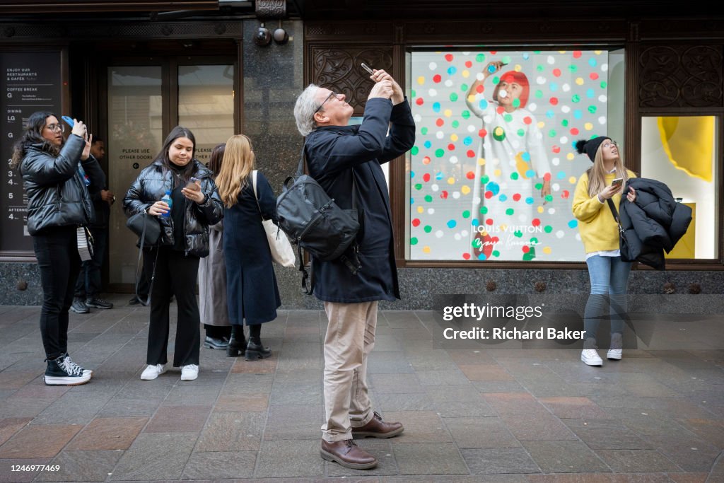Members of the public interact with a screen featuring the artist News  Photo - Getty Images