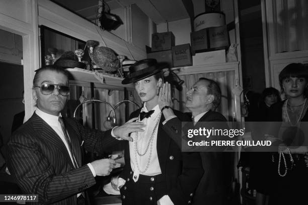 German fashion designer Karl Lagerfeld and French hairdresser Alexandre de Paris prepare a model backstage ahead of the presentation of spring-summer...