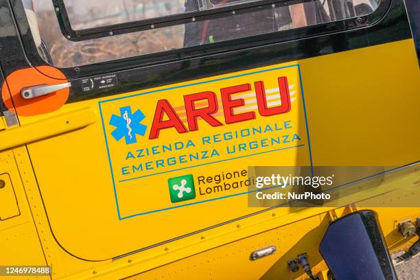 Logo AREU - Azienda Regionale Emergenza Urgenza printed on the side of medical helicopter, in Cernusco sul Naviglio, Italy, on February 10, 2023.