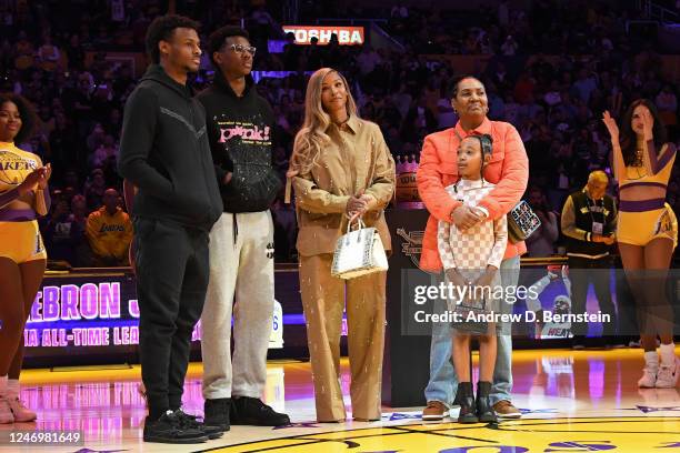 LeBron Jamess family poses for a photo during a ceremony to honor him becoming the NBA All Time Leading Scorer before the game against the Milwaukee...