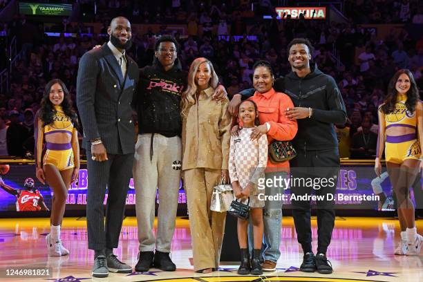 LeBron James and his family poses for a photo during a ceremony to honor him becoming the NBA All Time Leading Scorer before the game against the...