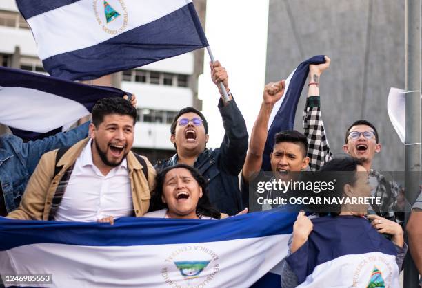 Nicaraguans living in exile in Costa Rica celebrate in San Jose, on February 9 after Nicaragua freed over 200 detained opposition members and...