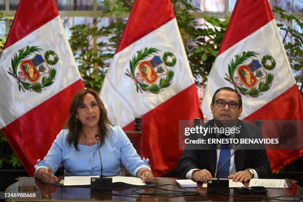 Peru's President Dina Boluarte speaks next to Prime Minister Alberto Otarola during a press conference at the Presidential Palace in Lima on February...